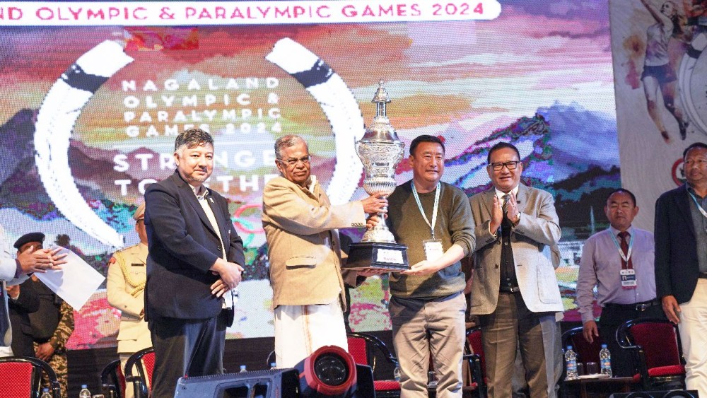 Nagaland Governor La Ganesan flanked by Dy CM TR Zeliang and other dignitaries presents a trophy to a winner during the closing ceremony of the 3rd Nagaland Olympic and Paralympic 2024 at Sovima on February 17. (NOA Photo)